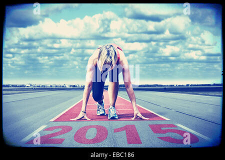 Female sprinter waiting for the start on an airport runway.In the foreground perspective view of the  date 2015. Stock Photo