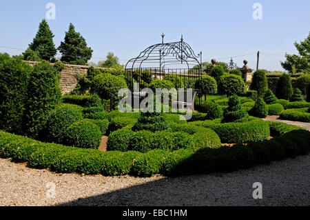 Topiary border at Bourton House garden Stock Photo