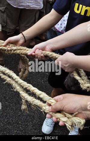 Naha Okinawa Japan people pulling the big rope along the Route 58 Stock ... picture photo