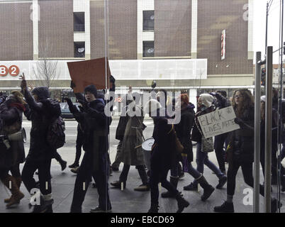 Chicago, Illinois, USA. 28th Nov, 2014. Protesters of the shooting of 18 year old black youth Michael Brown by police officer Darren Wilson in Ferguson, Missouri show their dissent by marching in front of retail stores on the major shopping day following Thanksgiving (Black Friday). The group in this picture marched by the Apple store on North Avenue in Chicago. They were chanting, ''Hands up, don't shoot.'' as they walked past the store. Some of the protesters displayed signs voicing their objections. Credit:  Karen I. Hirsch/ZUMA Wire/ZUMAPRESS.com/Alamy Live News Stock Photo