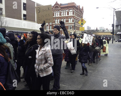 Chicago, Illinois, USA. 28th Nov, 2014. Protesters of the shooting of 18 year old black youth Michael Brown by police officer Darren Wilson in Ferguson, Missouri show their dissent by marching in front of retail stores on the major shopping day following Thanksgiving (Black Friday). The group in this picture marched by the Apple store on North Avenue in Chicago. They were chanting, ''Hands up, don't shoot.'' as they walked past the store. Some of the protesters displayed signs voicing their objections. Credit:  Karen I. Hirsch/ZUMA Wire/ZUMAPRESS.com/Alamy Live News Stock Photo