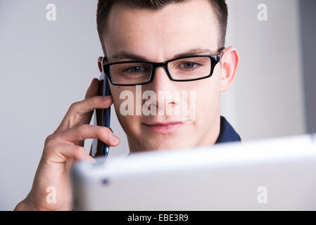 Young Man Working in Office, Mannheim, Baden, Wurttemberg, Germany Stock Photo