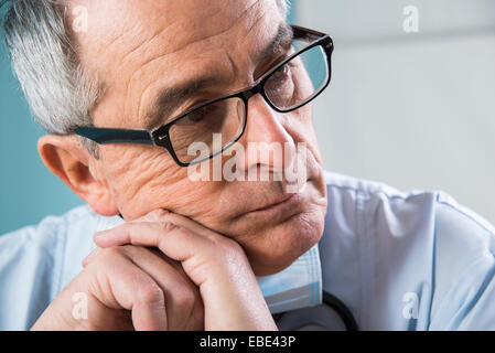 Close-up of Doctor leaning on hands Stock Photo