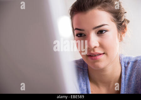 Close-up of young woman working in office on desktop PC, Germany Stock Photo