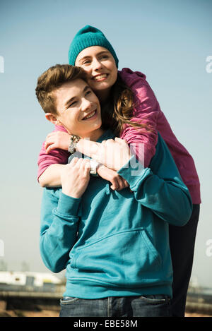 Close-up portrait of teenage couple embracing outdoors, Germany Stock Photo