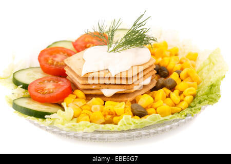 Snacks with vegetables, crackers and cheese cream on plate. Stock Photo