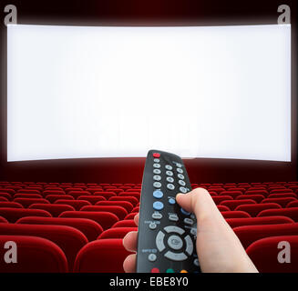 cinema screen with remote control in hand Stock Photo