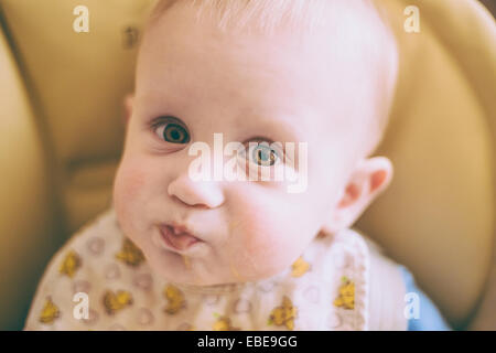 Portrait Of Happy Curious Young Baby Boy Eating Porridge Stock Photo