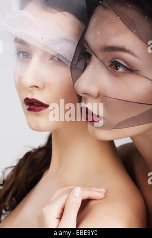 Fondness. Two Females in Veils Embracing Stock Photo