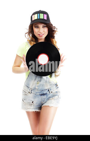 Cute Young Woman in Jeans Shorts holding Vinyl Record Stock Photo