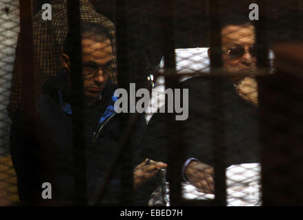 Cairo, Egypt. 29th Nov, 2014. Egypt's former president Hosni Mubarak with his son Gamal Mubarak are seen inside the court in Cairo, Egypt, Nov. 29, 2014 after a court dismissed a murder charge against the ousted leader over the deaths of protesters during a 2011 uprising that ended the former strongman's decades-long rule. The court also acquitted Mubarak of a corruption charge, but he will remain in prison because he is serving a three-year sentence in a separate corruption case © Stringer/APA Images/ZUMA Wire/Alamy Live News Stock Photo