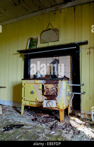 Abandoned dwelling at Lingreabhagh, Isle of Harris, Outer Hebrides, Scotland. With a range cooker in front of a fire place. Stock Photo