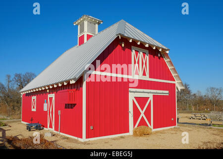 Small red barn found on a rural farm or ranch mainly used for storage in the United States. Stock Photo