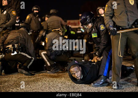 Ferguson, USA. 28th Nov, 2014. Policemen arrest a protester in front of the Ferguson PD Station in Ferguson, Missouri, the United States, on Nov. 28, 2014. Police arrested 15 people Friday night as about 100 protesters blocked traffic in front of the local police department in Ferguson. The protest was the latest one in reaction to the non-indictment of police officer Darren Wilson, who shot and killed unarmed 18-year-old black youth Michael Brown in August. © Jim Vondruska/Xinhua/Alamy Live News Stock Photo