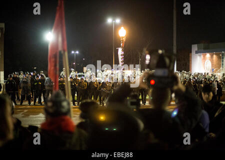 Ferguson, USA. 28th Nov, 2014. Protesters use a loud speaker to chant and communicate their views toward National Guard and Police Forces in Ferguson, Missouri, the United States, on Nov. 28, 2014. Police arrested 15 people Friday night as about 100 protesters blocked traffic in front of the local police department in Ferguson. The protest was the latest one in reaction to the non-indictment of police officer Darren Wilson, who shot and killed unarmed 18-year-old black youth Michael Brown in August. © Jim Vondruska/Xinhua/Alamy Live News Stock Photo