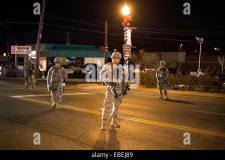 Ferguson, USA. 28th Nov, 2014. National Guard stand guard north of the Ferguson PD Station as protesters are dispersed and arrested after blocking the street in Ferguson, Missouri, the United States, on Nov. 28, 2014. Police arrested 15 people Friday night as about 100 protesters blocked traffic in front of the local police department in Ferguson. The protest was the latest one in reaction to the non-indictment of police officer Darren Wilson, who shot and killed unarmed 18-year-old black youth Michael Brown in August. © Jim Vondruska/Xinhua/Alamy Live News Stock Photo