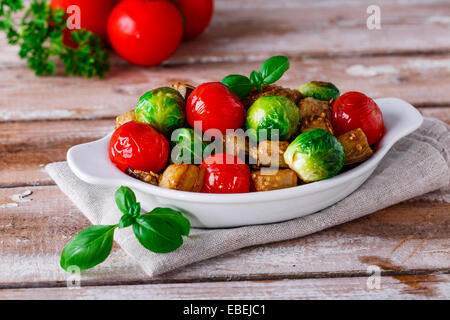 roasted vegetables eggplant, brussel sprouts, tomatoes basil Stock Photo
