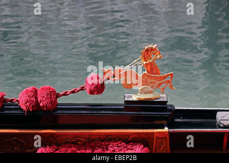 Venice Italy San Marco red gondola interior reflects on brass ornament Stock Photo