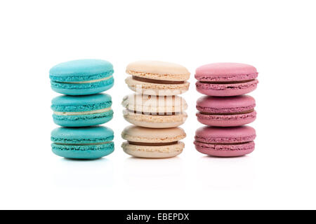 Three stacks of multicolored macaroons isolated on white background Stock Photo