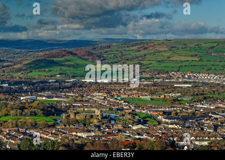 Vista of a town in a valley with a castle in the foreground and rolling hills in the distance, Stock Photo