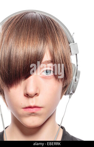 serious teenage boy with headphones, isolated on white Stock Photo