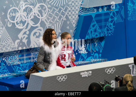 Yulia Lipnitskaya (RUS) and her coach Eteri Tutberidze in the kiss and cry area after competiting in the Women's Figure Skating Stock Photo