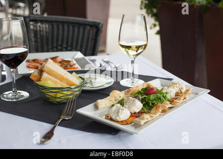 Italian meal with wine on outdoor patio table Stock Photo