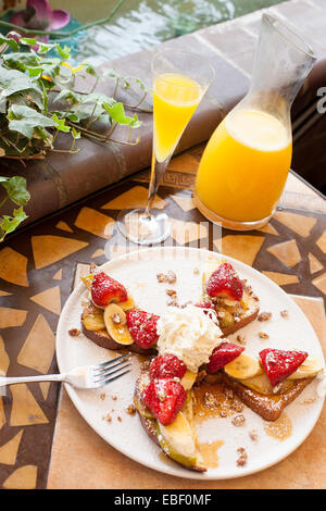 French Toast And Mimosa At Brunch In Garden Patio Setting Stock Photo 