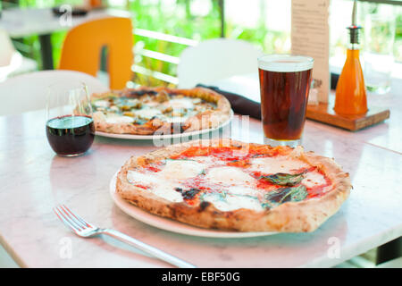 Pizzas and beverages on marble table outdoor Stock Photo