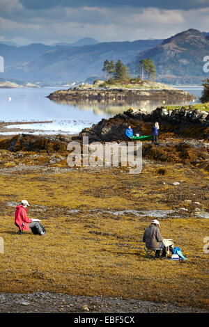 Artists paint the view of Loch Carron from Plockton Village bay. Stock Photo