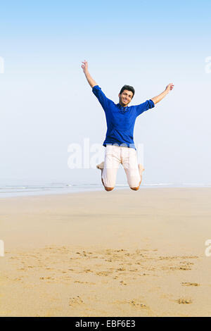 indian man Sea Side Jumping Stock Photo