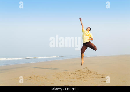 indian man Sea Side Jumping Stock Photo