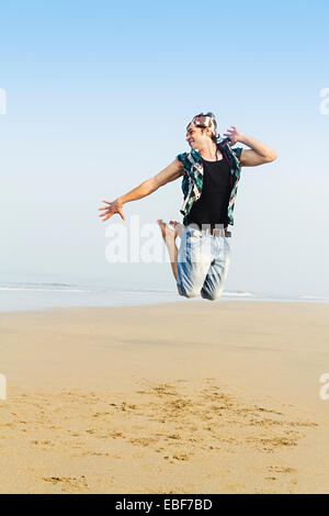 indian man Sea Side Jumping Stock Photo