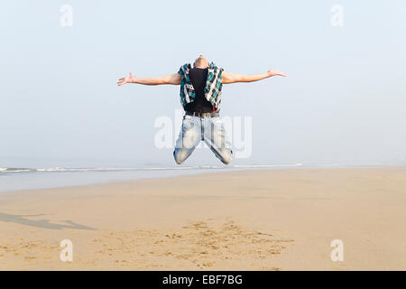 indian man Sea Side Jumping Stock Photo