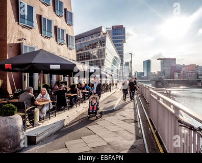 Tourists sitting in a sidewalk cafe in Dusseldorf Media Harbor Stock Photo