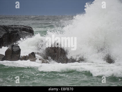 A dark day with autumn or winter storms on Jaeren, west coast of Norway near Stavanger waves breaking over rocks and beach Stock Photo
