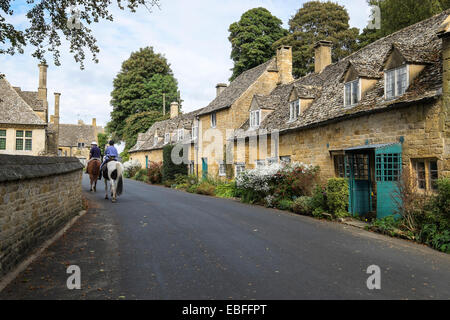 Snowshill manor holiday cottages and horse riders Snowshill village The Cotswolds Gloucestershire England Stock Photo
