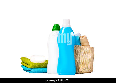 Detergent in blue and white plastic bottles with fresh towels and measuring cup isolated on white background. Bottle with liquid Stock Photo