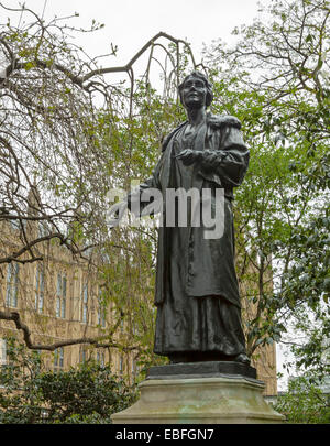 Statue of Emmeline Pankhurst in Victoria Tower Gardens ( Palace of Westminster in background ), London, England, United Kingdom. Stock Photo