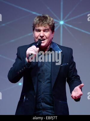 Riesa, Germany. 30th Nov, 2014. Singer Frank Schoebel performs during the start of the tour 'Weihnachten in Familie' (Christmas in the Family) in Riesa, Germany, 30 November 2014. The program offers a foray into their current and popular titles with a small show interlude. After the start in Riese, there will be 16 more stops on the tour including Magdeburg, Chemnitz and Gera. Photo: HENDRIK SCHMIDT/dpa/Alamy Live News Stock Photo