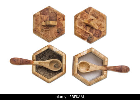 Two wooden condiment pots with spoons and lids on a flagstone floor ...