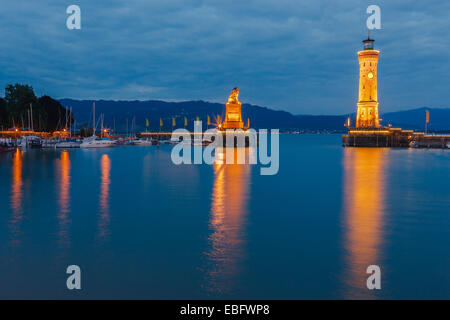 View of harbor entrance and lighthouse at night in Lindau at lake Constance, Bavaria, Germany Stock Photo