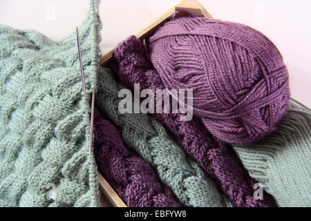 wool with needles in cage Stock Photo