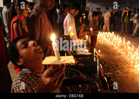 Bhopal, India. 30th Nov, 2014. Second generation children born with congenital diseases caused by the exposure of their parents to the gas leakage in the 1984 Bhopal gas tragedy, participate in a candlelight vigil to pay homage to the people killed in the tragedy, ahead of 30th anniversary of gas disaster in Bhopal, India, Nov. 30, 2014. It is believed that thousands of people were killed in the disaster. © Stringer/Xinhua/Alamy Live News Stock Photo