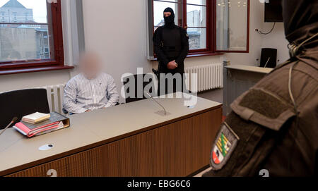 Halle, Germany. 01st Dec, 2014. The defendant Norman S. (L) sits in the courtroom at the start of the trial in the regional court in Halle, Germany, 01 December 2014. He is on trial for attempted murder and grievous bodily harm. He attempted, among other things, to kill the member of a biker gang with five shots from a pistol. Photo: PETER ENDIG/dpa (defendants face pixelated for legal reasons)/dpa/Alamy Live News Stock Photo