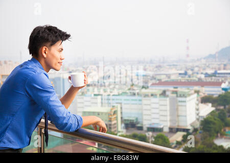 relaxed businessman watching the city view Stock Photo