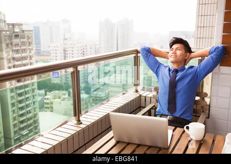 relaxed young business man watching the city view Stock Photo