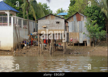 riparian scenery with shacks at a river in Cambodia Stock Photo