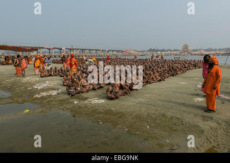 Sitting in silence as part of the initiation of new sadhus at the Sangam, the confluence of the rivers Ganges Stock Photo