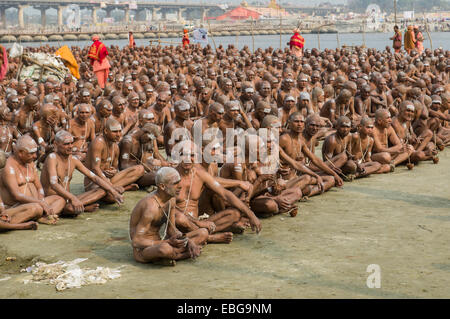 Sitting in silence as part of the initiation of new sadhus at the Sangam, the confluence of the rivers Ganges Stock Photo